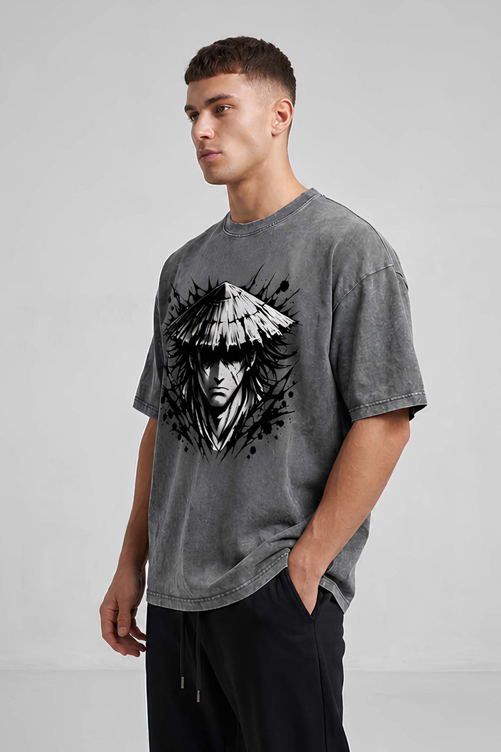 Man wearing a gray t-shirt with a black and white graphic design on a plain background